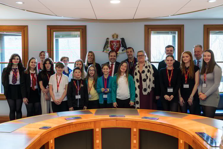 Island schoolchildren with Ministers as the new policy is received by Tynwald