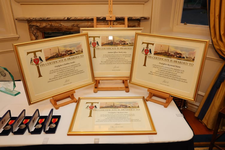 Certificates and medals lined up on display
