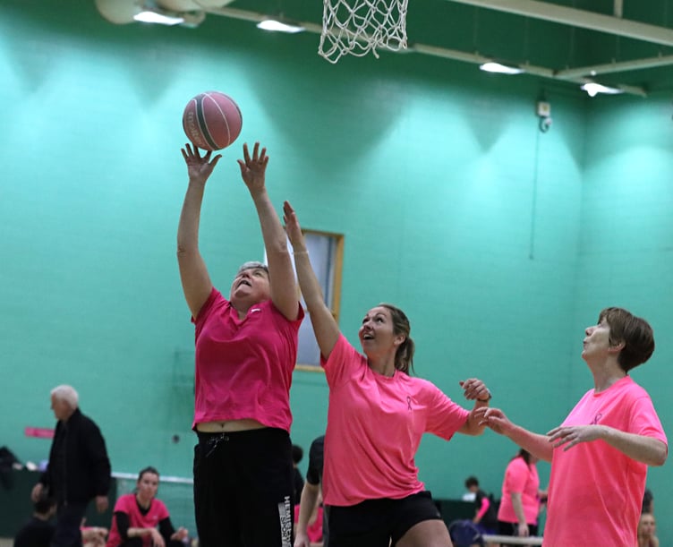 Hoops player Dannielle Murphy (centre) challenges an opponent for a rebound during the Big Pink Game in aid of the Manx Breast Cancer Support Group on Sunday (Photo: Eoin Dunne)