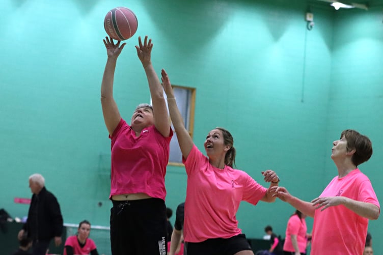 Hoops player Dannielle Murphy (centre) challenges an opponent for a rebound during the Big Pink Game in aid of the Manx Breast Cancer Support Group on Sunday (Photo: Eoin Dunne)