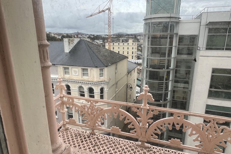 The upper-floor windows with their decorative metalwork balconies have impressive views out over Douglas 