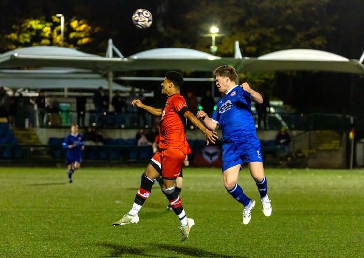 FC Isle of Man's Adam Adebiyi (left) challenges for an aerial ball during Saturday evening's match against Longridge Town at the Bowl (Photo: Hannah McHugh)