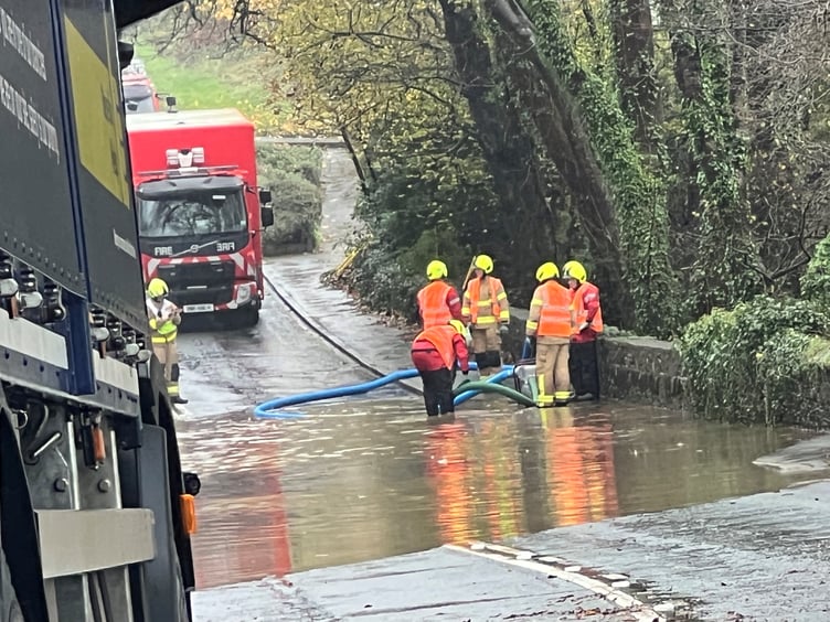 Fire crews pump floodwater away from the bottom of Brown Cow Hill