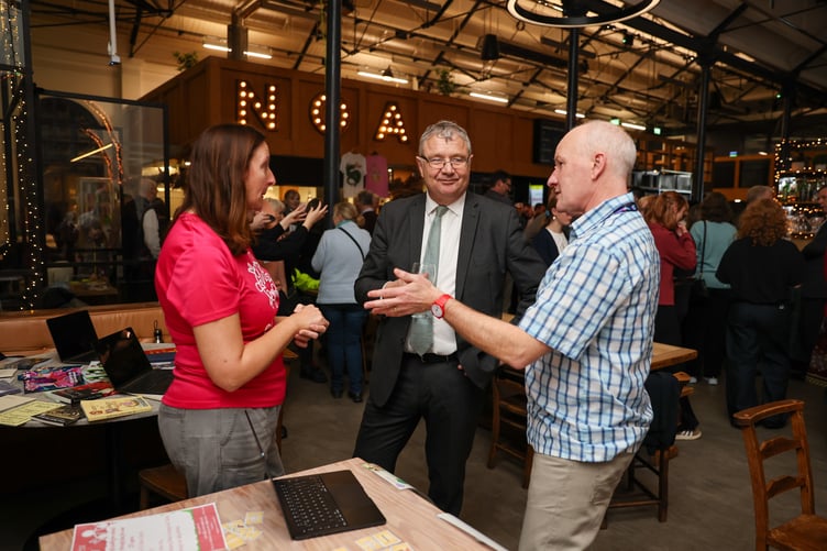 Chris Thomas MHK in conversation with representatives of the Mooinjer Veggey charity