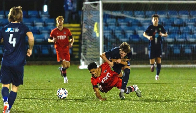 FC Isle of Man's Adam Adebiyi is sent tumbling to the Astroturf by a Pilkington defender during Saturday's Premier Division clash at the Bowl (Photo: Hannah McHugh)