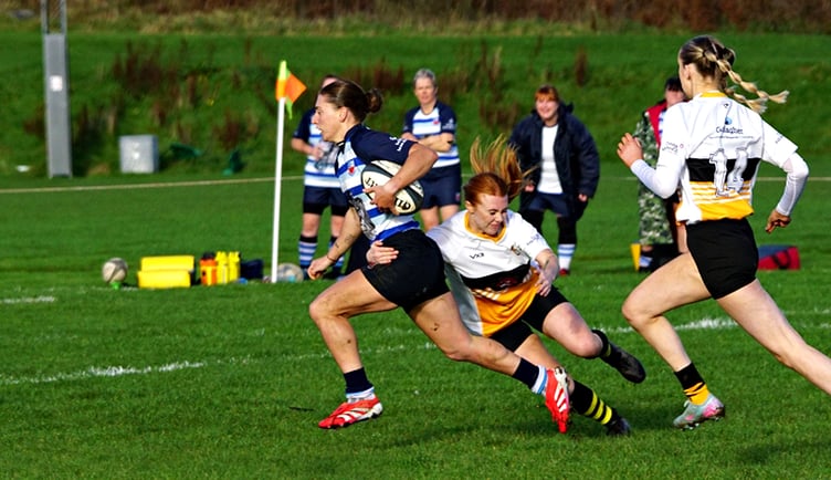 Winnington Park’s hat-trick hero Charlie Hignett is tackled by Vagabonds' Holly Scott during Saturday's clash at Ballafletcher (Photo: John Liver/Mumble's Pics)