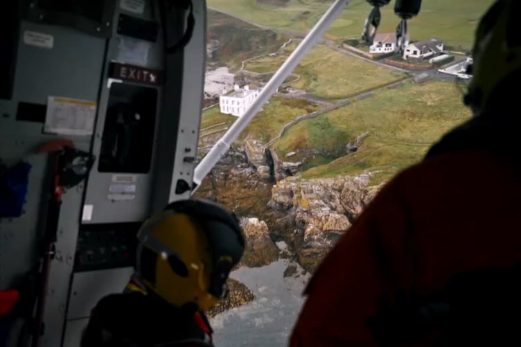 Coastguard helicopter flying over Port St Mary