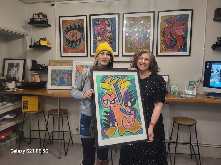 Artist Kim Cowell (left) with Ria Sheridan from the Samaritans with one of Kim's paintings