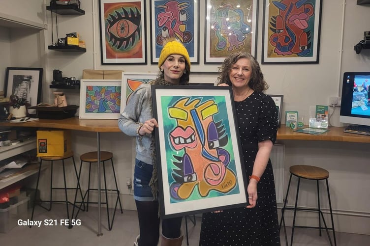 Artist Kim Cowell (left) with Ria Sheridan from the Samaritans with one of Kim's paintings
