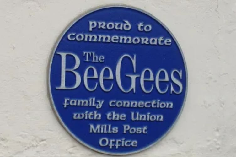 A blue plaque on the building marks the spot where the Gibb family once ran the local post office