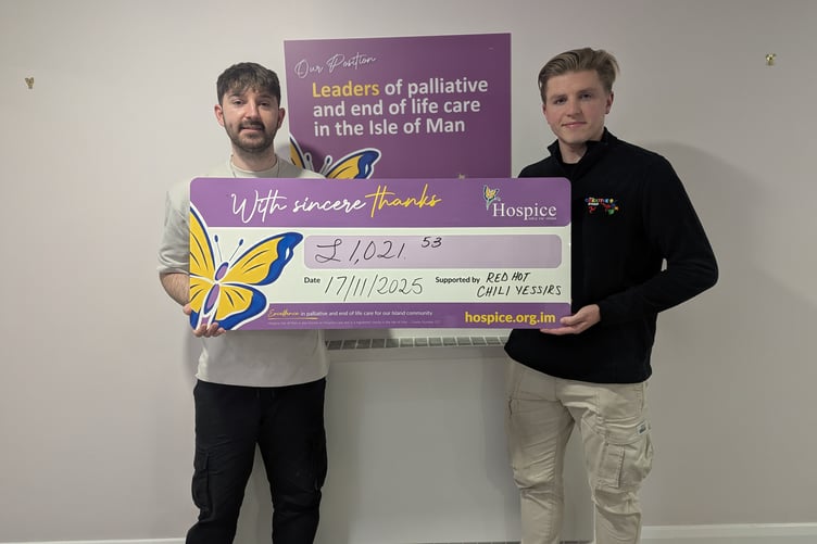 Jordan Kirk with fellow band member Kieran Brown presenting the cheque to Hospice.