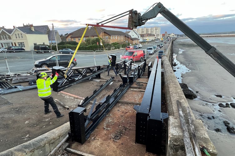 Replacement steelwork is lifted from the compound to beach level