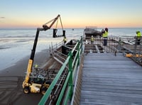 Watch as volunteers race against time and tide to help restore pier