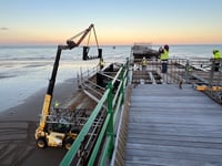 Watch as volunteers race against time and tide to help restore pier