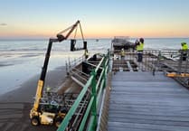 Watch as volunteers race against time and tide to help restore island pier