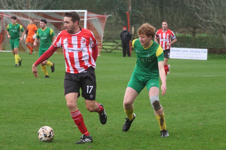Peel's Daniel Bell and St Mary's Tom Callow in action at Douglas Road last weekend (Photo: Paul Hatton)