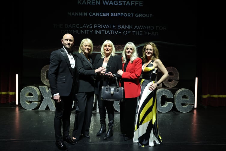 Mannin Cancer Support Group accept the award on stage