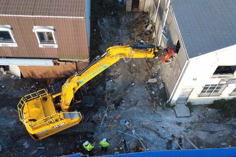 Contractors tear down the walls of the Antiques Centre