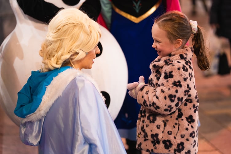 A young girl chats with Elsa from Frozen