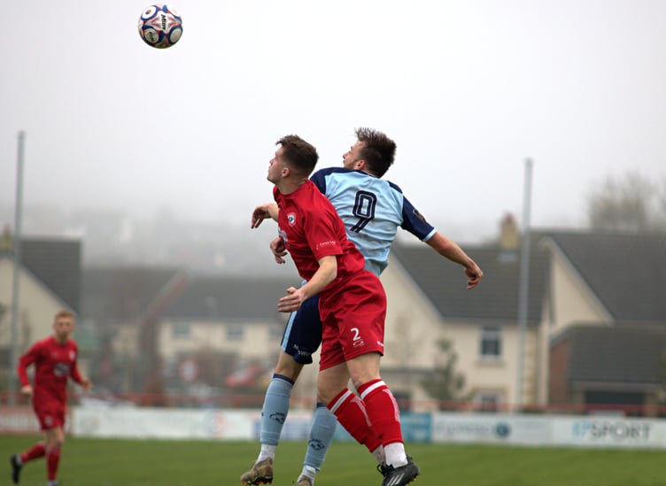 FC Isle of Man striker Luke Booth (No9) rises high to challenge for a header against a Longridge Town opponent during Saturday's Premier Division clash in Lancashire (Photo: Kassidy's Photography)