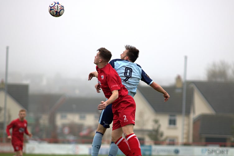 FC Isle of Man striker Luke Booth (No9) rises high to challenge for a header against a Longridge Town opponent during Saturday's Premier Division clash in Lancashire (Photo: Kassidy's Photography)