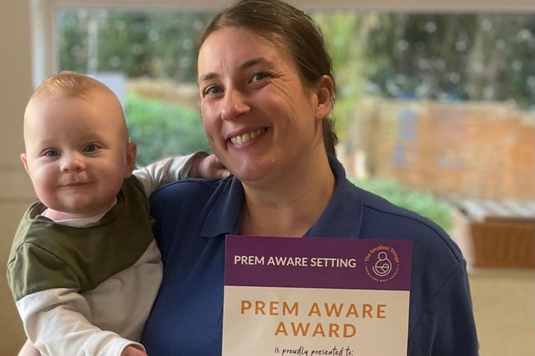 Luca with Miss Emma, a member of the Beehive Kindergarten team