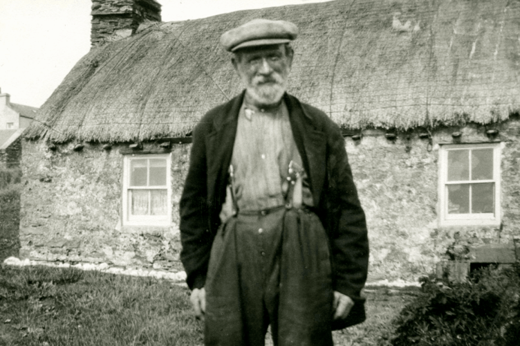 Harry Kelly outside his cottage