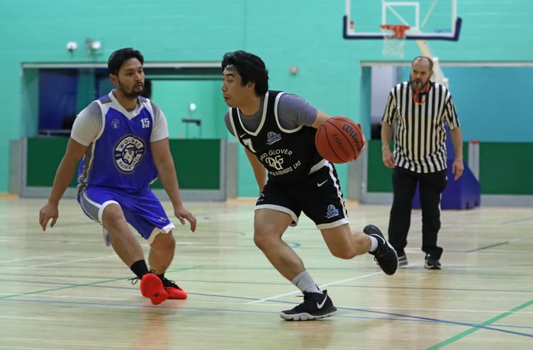 DGU Jets' Revi Del Rosario drives the baseline as Wolves' Luke Geneza shifts on defence during their Senior League match-up at the NSC on Thursday evening (Photo: Martin Dunne)