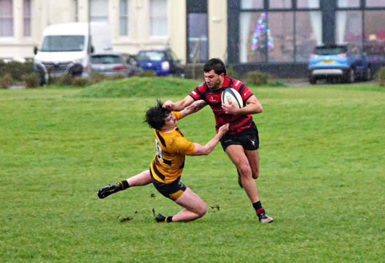 Ramsey’s Adam Dempsey fends off a tackle from a Vagabonds opponent during last weekend's local derby match at Mooragh Park (Photo: John Liver/Mumble's Pics)