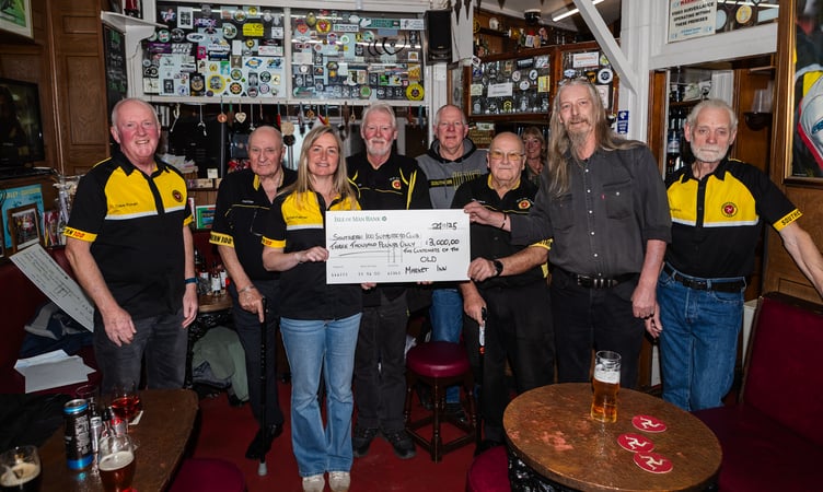 Old Market Inn landlord Colin Scott (second from right) presents a cheque for £3,000 to Southern 100 Supporters Club secretary Rachel Palmer and other members of the club from monies raised throughout this year (Photo: Ryan Crawley)