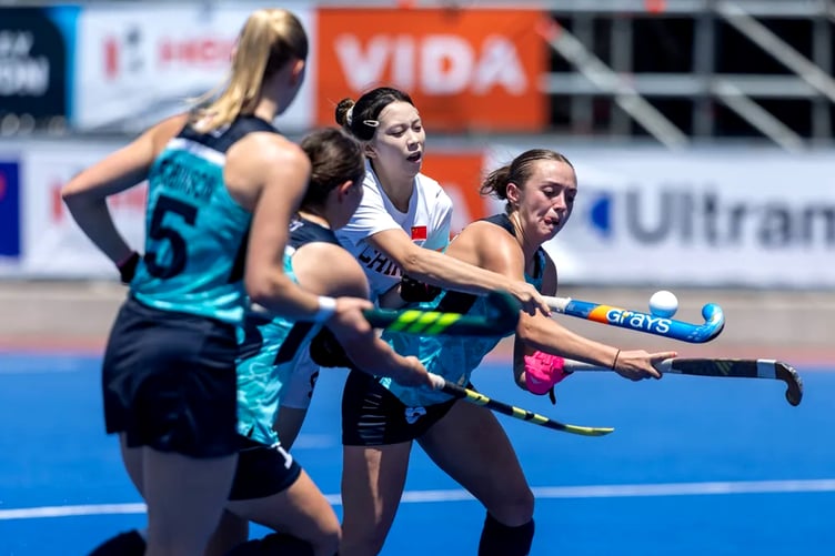 Sienna Dunn (right) battles for the ball during England's opening match with China in the Women's Junior World Cup on Tuesday (Photo: Fédération Internationale de Hockey)