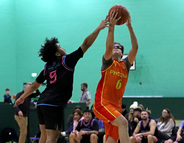 Southern Phoenix's Zac Hand draws the foul on the lay-up from Pirates' Lance Davidas. Hand hit the basket and subsequent free-throw for a solid three-point play to end the game (Photo: John Long)