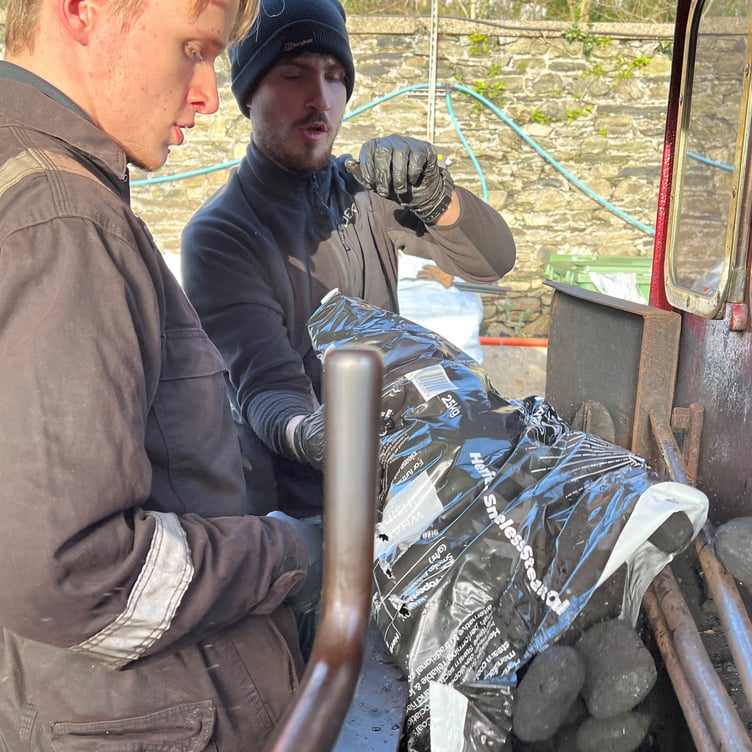 Another bag of coal ovoids is tipped into the loco's bunker