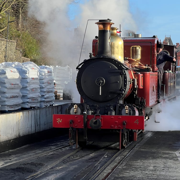 Bags of the manufactured smokeless steam coal coal stacked up at Douglas railway depot