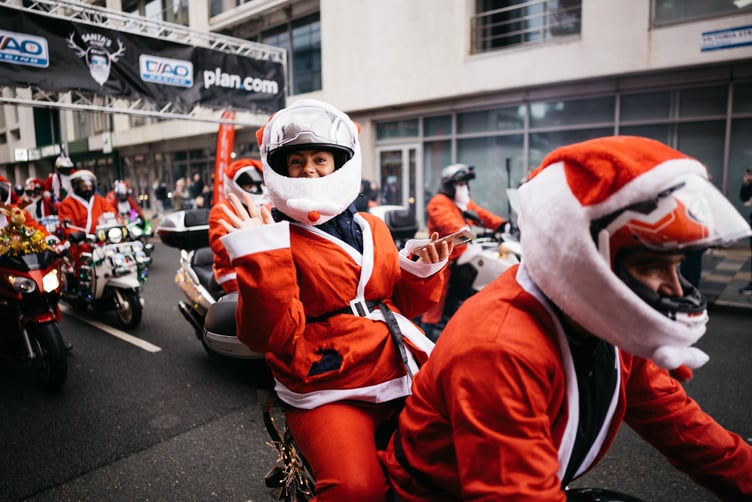 A big wave from a Santa at the start line