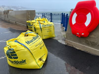 Pictures as sandbags replace capital's damaged new sea defences