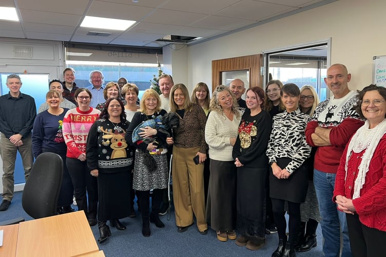 Dennis with his Sterling Group family - holding him is his owner Lesley