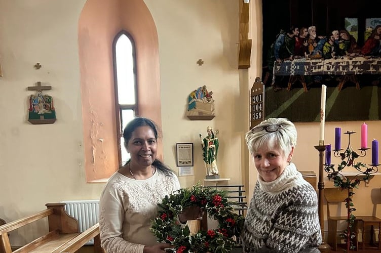 Jane Curphey (right) gifts a homemade wreath to St Patrick's Church 