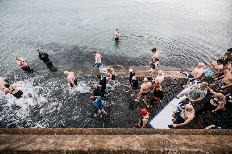 The first swimmers enter the water at the Port St Mary New Year's Day dip