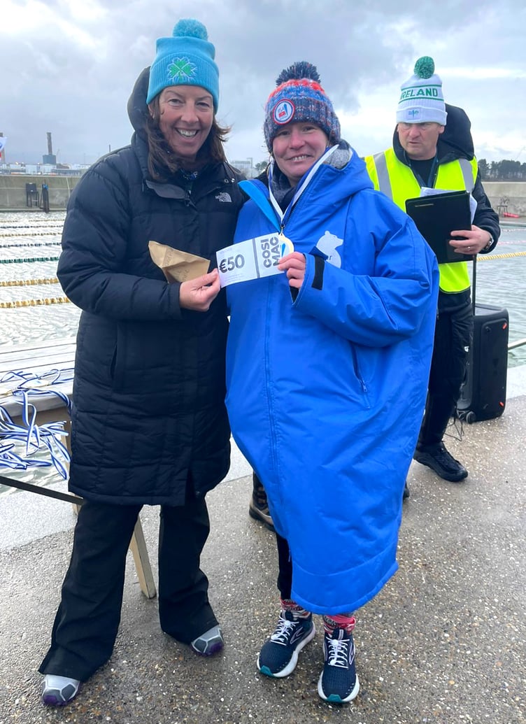 Isle of Man swimmer Carole Laporte (right) receives her prize money after winning both the 1km and the 250m women's events at the 2025 IISA Ireland National Ice Swimming Championships in Dublin recently