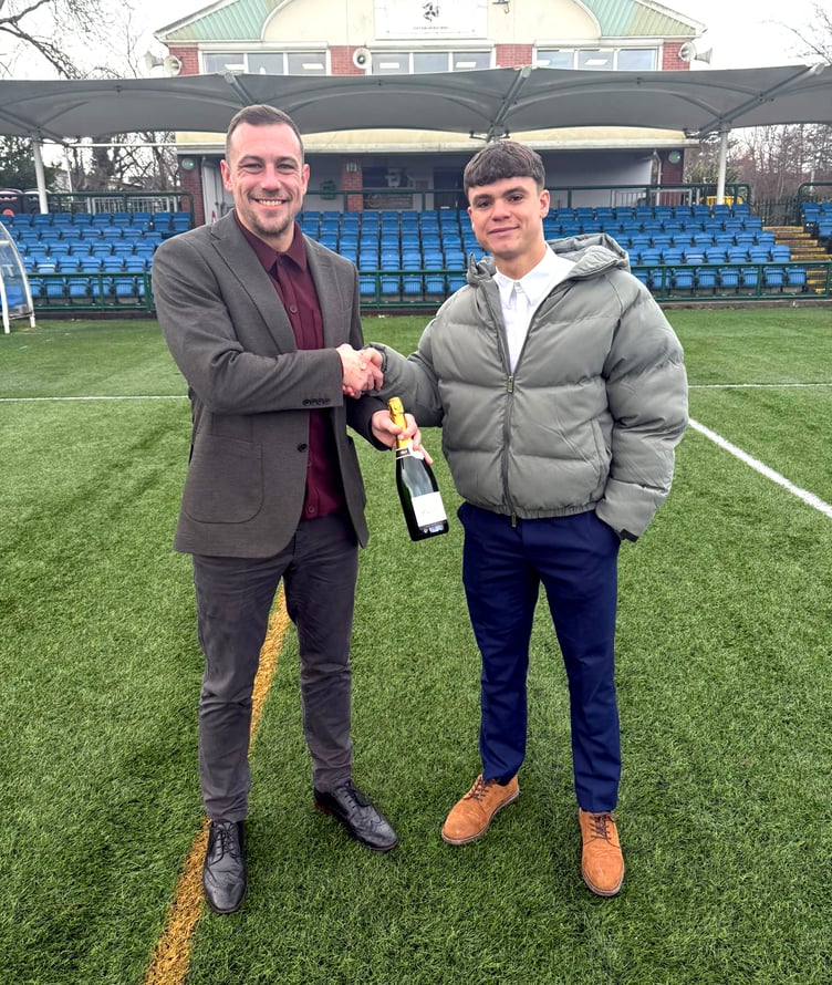 Dave Wilson (right) receives his Player of the Round bottle of Champagne from Carl Conroy of FA Cup sponsor Exchange Capital Partners (ECAP)