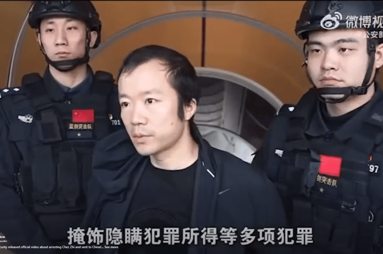 Chen Zhi is escorted by SWAT officers