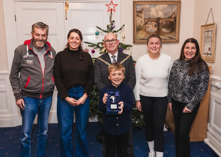 Logan Connor with his family and the Mayor