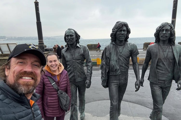 Extreme meteorologist Reed Timmer with his mum Susan at the Bee Gees statue in Douglas