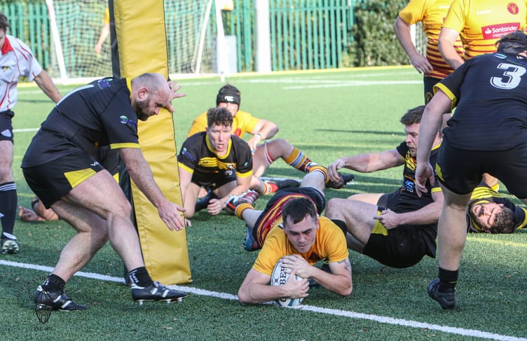 Nathan Robson dives over to score for Douglas RUFC on the 3G pitch at Burnage last season (Photo: Richard Ebbutt)