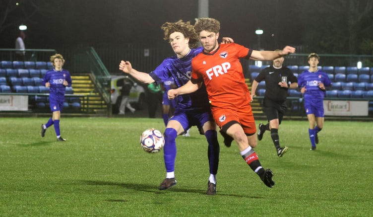 FC Isle of Man's Shaun Kelly (right) looks to escape the attentions of a South Liverpool player during Saturday evening's clash at the Bowl (Photo: Paul Hatton)