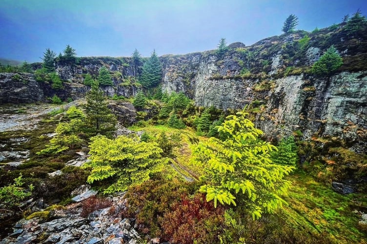 South Barrule quarry is lined with coniferous trees