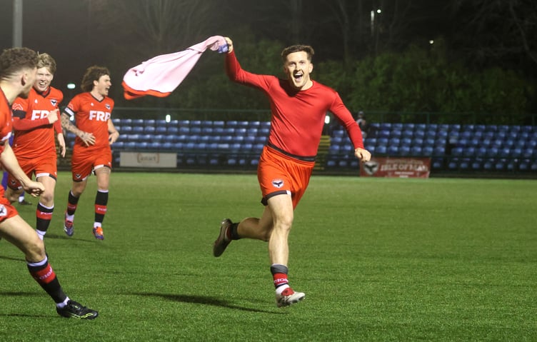 FC Isle of Man attacker Ste Whitley wheels away in celebration with his shirt waving in the air after scoring a superb later winning for the Ravens against South Liverpool at the Bowl on Saturday evening. Whitley danced past several challenges before unleashing a stunning 30-yard effort into the top right-hand corner to snatch a dramatic late victory for the Manx side. (Photo: Paul Hatton)