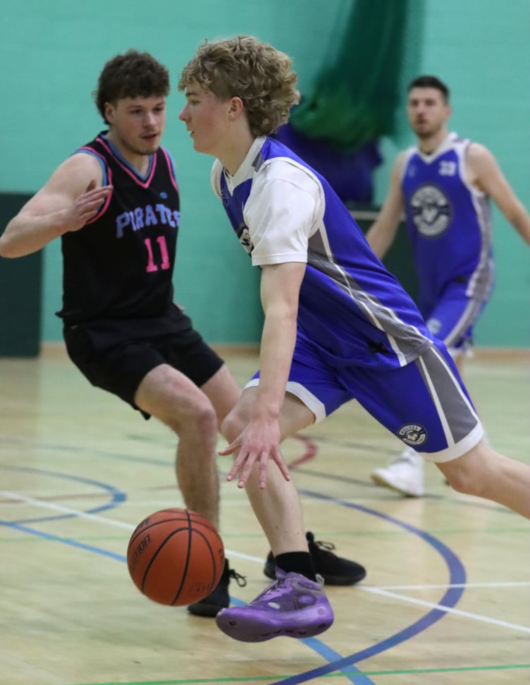 Wolves' Seb Smith drives to the hoop past the defence of Pirates newcomer Owen Chestnut. Smith had a standout game in his side's 95-36 victory with a career high 26 points (Photo: Martin Dunne)