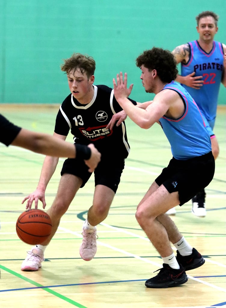 Jack Wilkinson drives to the hoop for Cannons Elite as Pirates' rookie Owen Chestnut defends the lane during Thursday evening's match at the NSC (Photo: Martin Dunne)